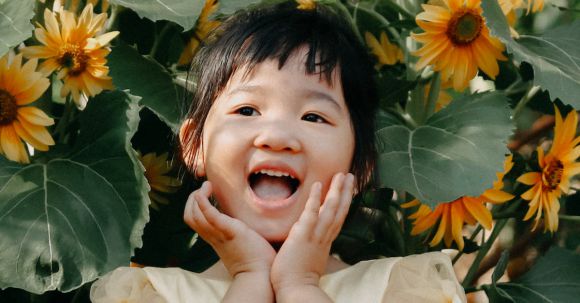 Children's Garden - Photo of Girl Standing Near Yellow Flowers