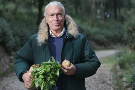 Garden Guide - Man in Green Fur Coat Holding Vegetable and Apple Fruit